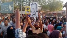 Protesters hold an image of teacher Ahmed al-Kheir, tortured and killed by Sudanese security forces - image: SPA via Facebook